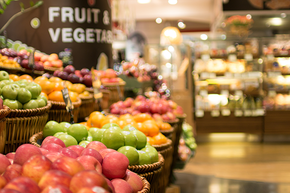 A grocery store aisle filled with fresh produce.