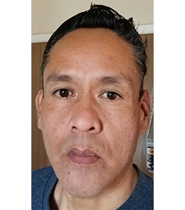 American Indian or Alaska Native with brown hair and brown eyes.