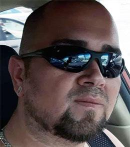 Hispanic male with brown eyes and black hair.