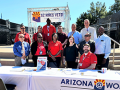 a group of people; a sign reads "AZ Hires Vets