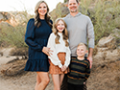 The Hillman Family taking a family portrait, with Gavin standing in the front.
