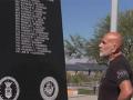 man standing before a veterans memorial