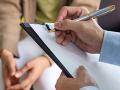 a person writing on a clipboard