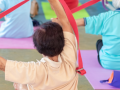 Elders use colorful bands in a yoga class