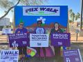 three women hold signs in support of the 2023 Walk to End Alzheimer's