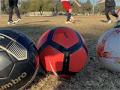 three colorful soccerballs