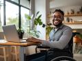 man in wheelchair using a laptop