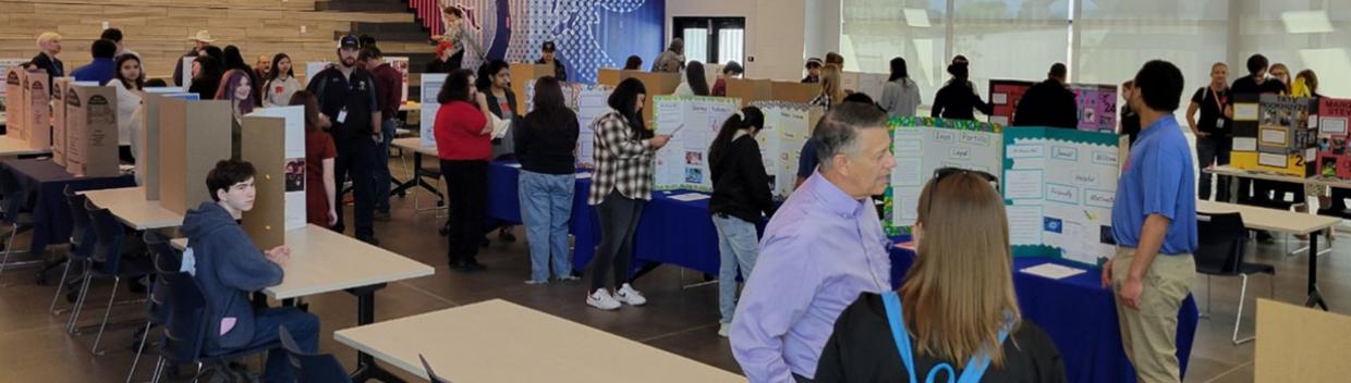 people gathered around booths at a job fair