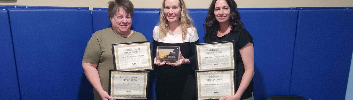 A group of women holding certificates