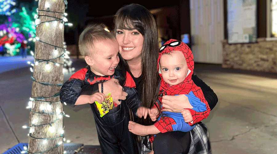 a woman holding two small children