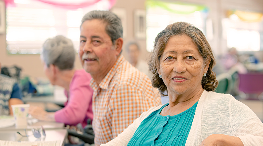 An older woman and man sitting at a table.