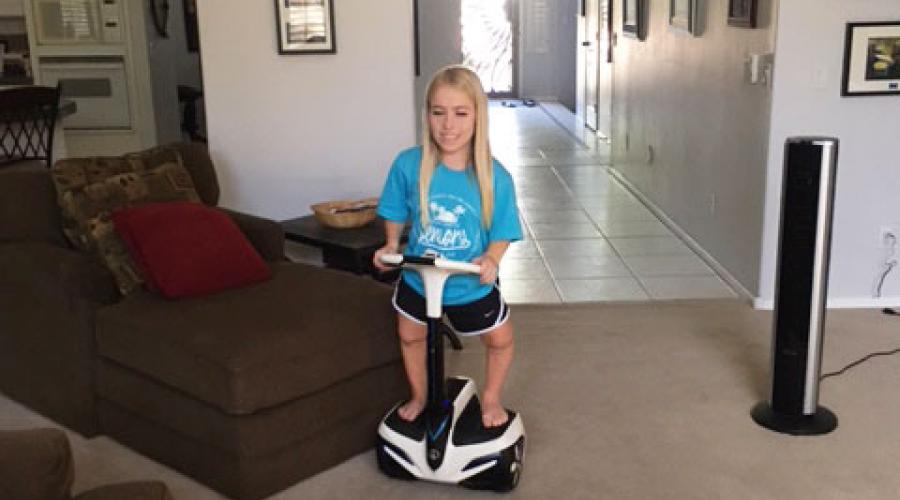 a young woman rides a scooter in her home