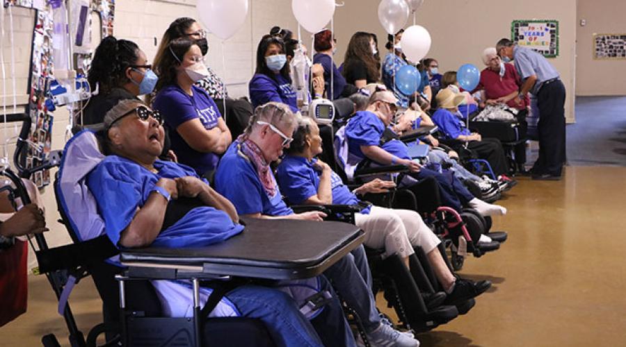 people sitting with their disabled relatives