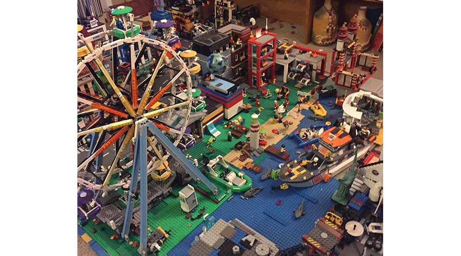 a city scape made of Legos toy blocks; a toy ferris wheel stands near the make-believe harbor