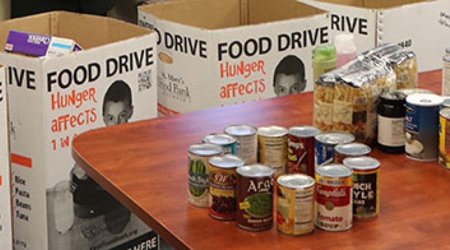 five large cardboard boxes containing canned food items