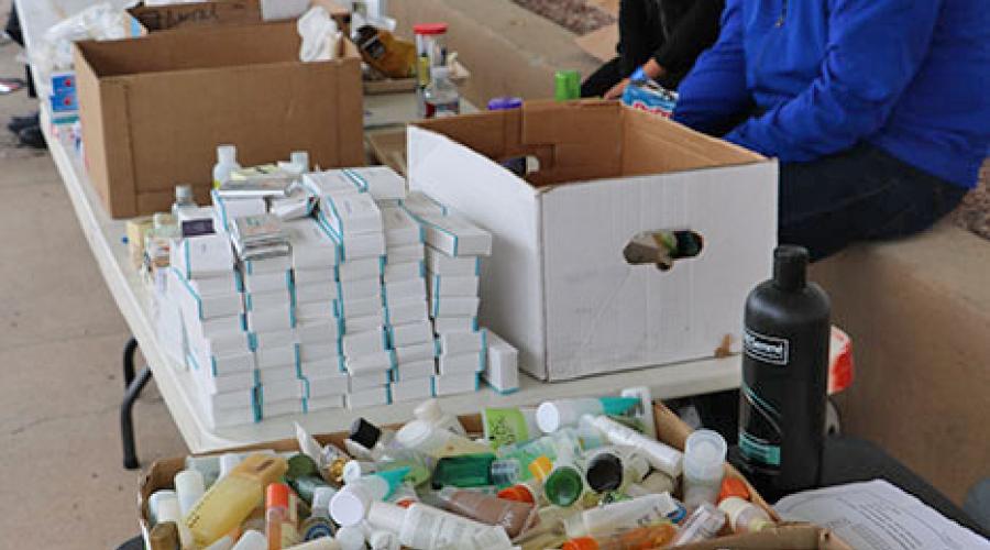 free hygiene products sit on table tops and in cardboard boxes