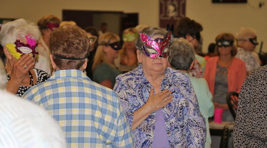 people wearing masquerade masks