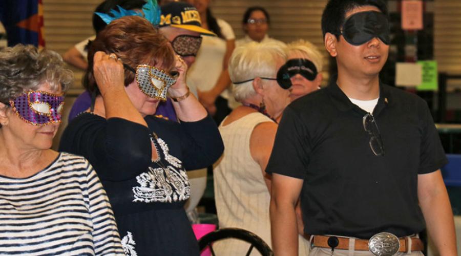 group of people wearing masquerade masks