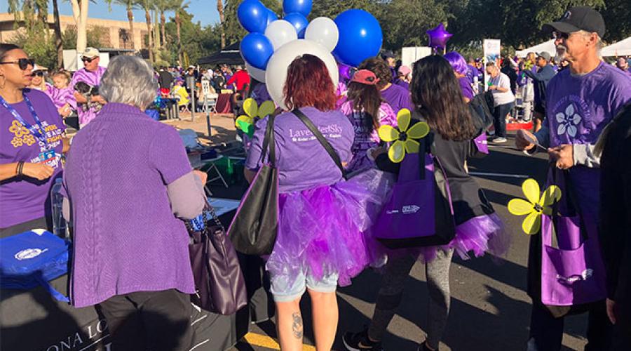 people wearing purple t-shirts and tutus