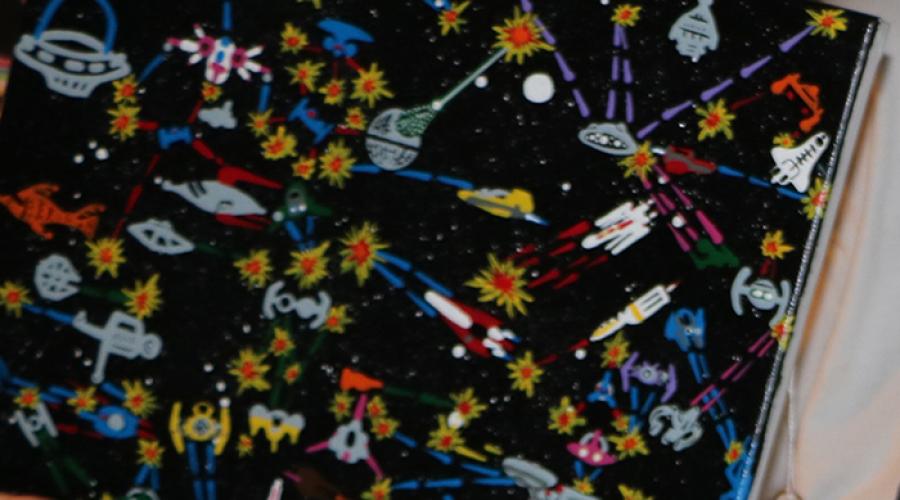 Close-up of painting featuring spaceships.