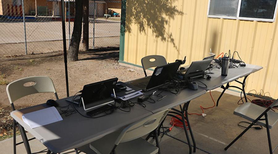 tables set up outside with laptop computers on them
