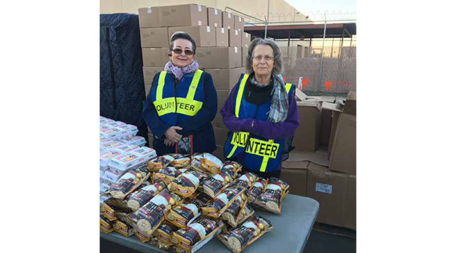 Two DES Volunteers at St. Mary’s Food Bank distributing food 