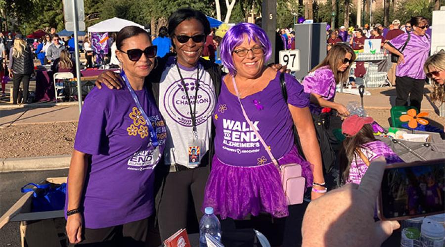 three women dressed in purple
