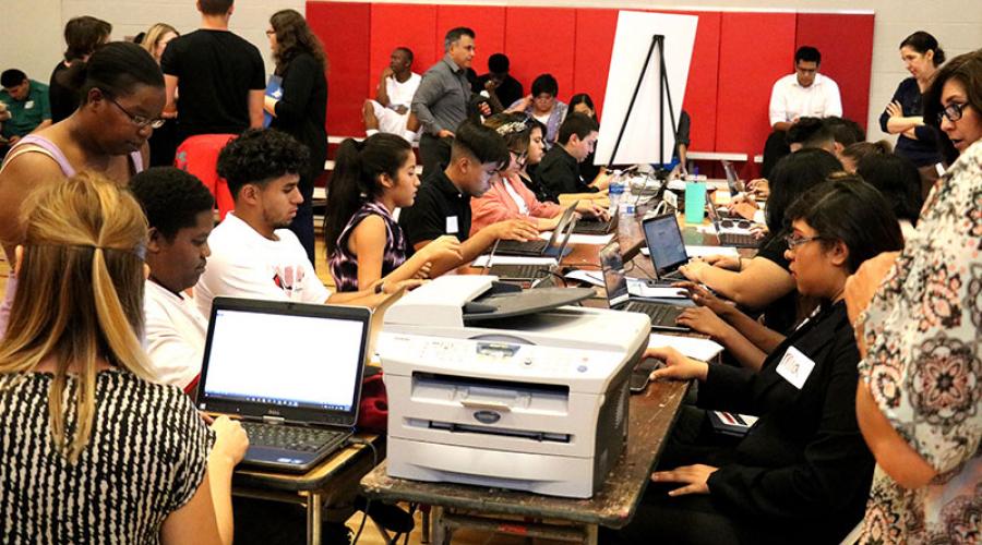 young job seekers work on computers to apply for jobs