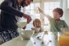 Father and kids in kitchen preparing breakfast