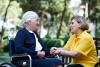 senior on wheelchair talking to caregiver