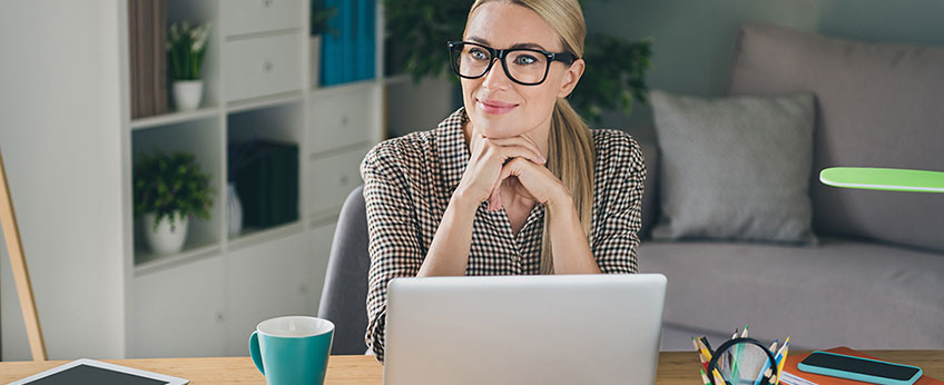 a woman sitting at a desk in her home office